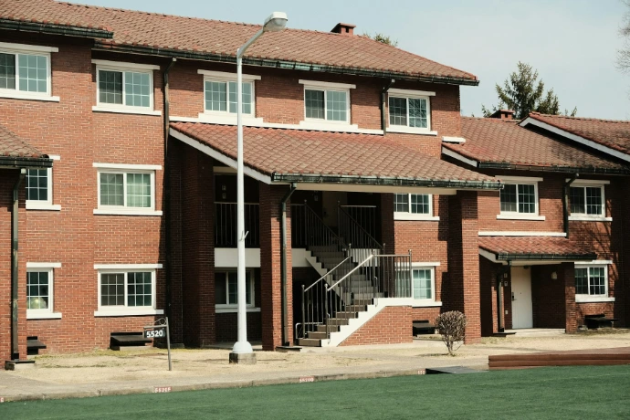 Brick apartment building with outdoor stairs and windows